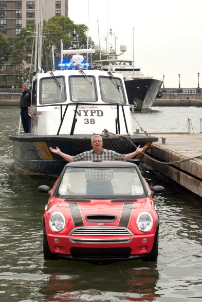 Dwight Miller, of Lancaster, Pa., pilots his Mini Cooper-style boat in the New York Harbor. His unique craft helped publicize the opening of the Motorexpo car show at the World Financial Center in Manhattan.