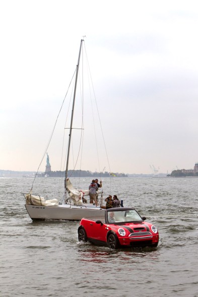 Dwight Miller, of Lancaster, Pa., pilots his Mini Cooper-style boat in the New York Harbor. His unique craft helped publicize the opening of the Motorexpo car show at the World Financial Center in Manhattan.