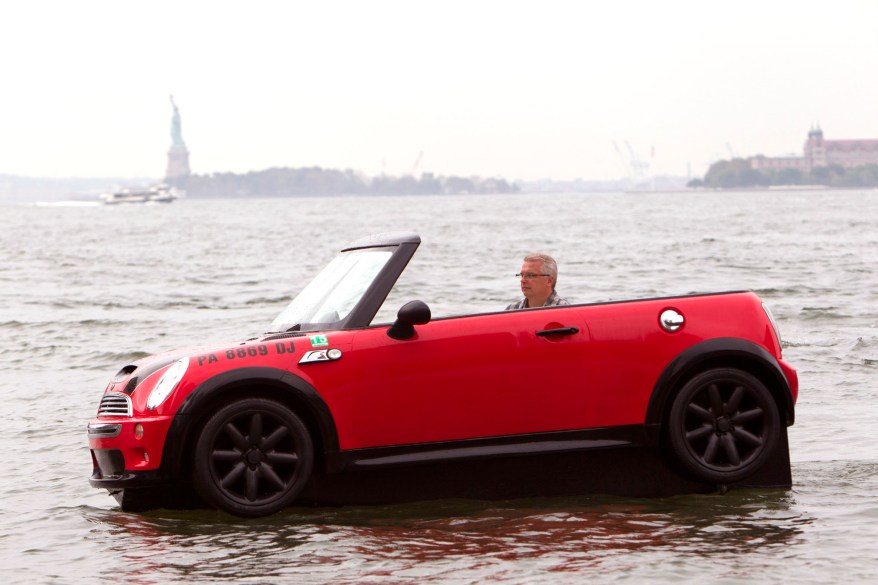 Dwight Miller, of Lancaster, Pa., pilots his Mini Cooper-style boat in the New York Harbor. His unique craft helped publicize the opening of the Motorexpo car show at the World Financial Center in Manhattan.