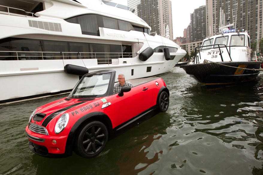 Dwight Miller, of Lancaster, Pa., pilots his Mini Cooper-style boat in the New York Harbor. His unique craft helped publicize the opening of the Motorexpo car show at the World Financial Center in Manhattan.