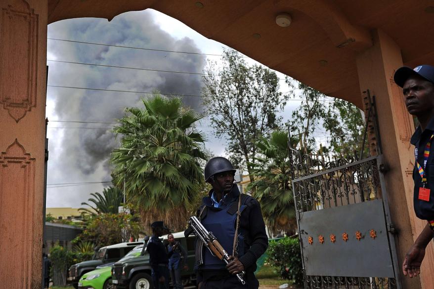 A Kenyan police officer mans on September 23, 2013 the entrance of a building in the vicinity of the beseiged Westgate