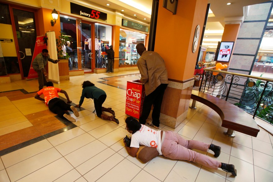 People scramble for safety as armed police hunt gunmen who went on a shooting spree at Westgate shopping centre in Nairobi