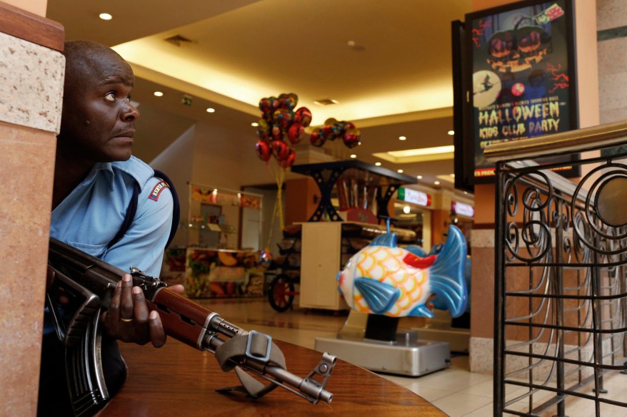 A police officer tries to secure an area inside the Westgate Shopping Centre where gunmen went on a shooting spree in Nairobi