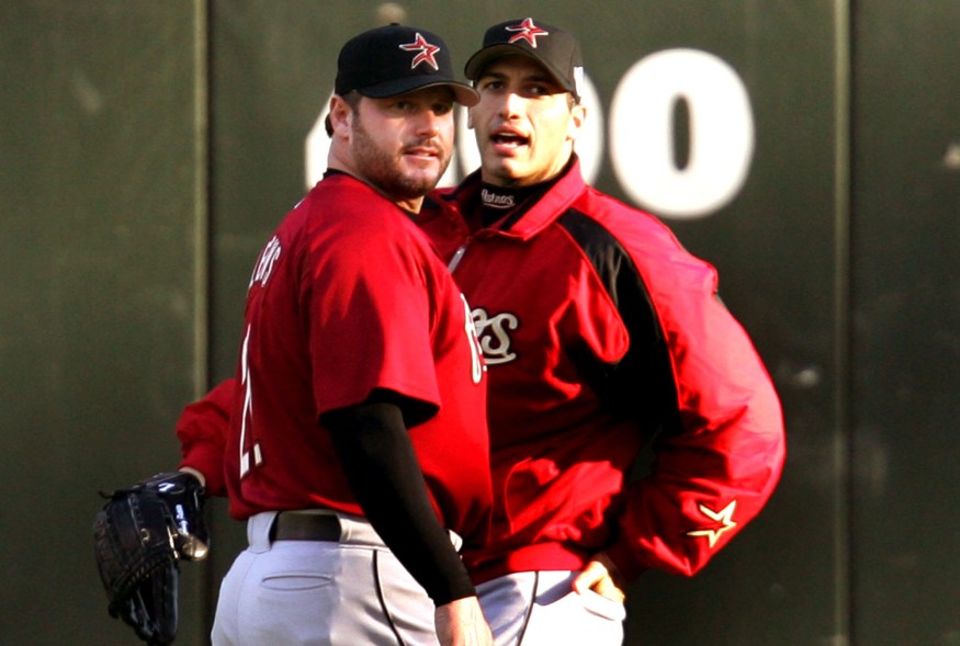 Houston Astros pitchers Andy Pettitte (R) and Roger Clemens walk in the outfield during a team practice before Game 1 of the World Series in Chicago October 21, 2005. Clemens will be the Astros starting pitcher when The American League champion Chicago White Sox will host the National league champion Houston Astros in Game 1 of the World Series in Chicago on Saturday.