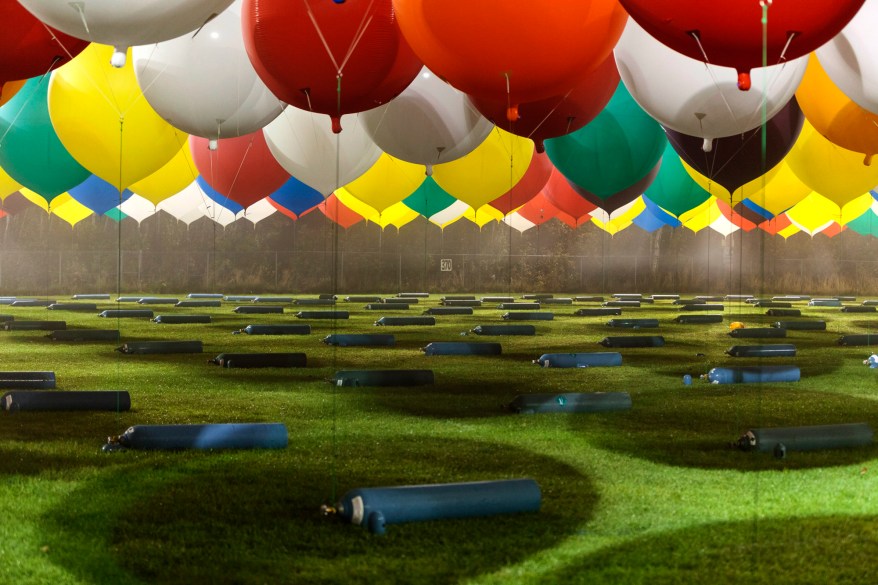 Jonathan Trappe is surrounded by balloons that will he will use to float across the Atlantic Ocean from Caribou, Maine.