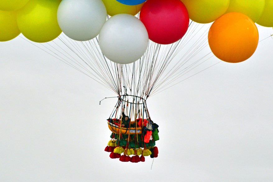 Jonathan Trappe is surrounded by balloons that will he will use to float across the Atlantic Ocean from Caribou, Maine.