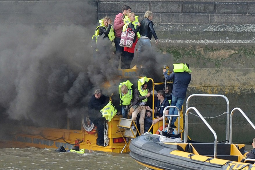 Passengers don life jackets and jump into the waters of the River Thames in London, England after their London Duck Tours boat caught on fire.