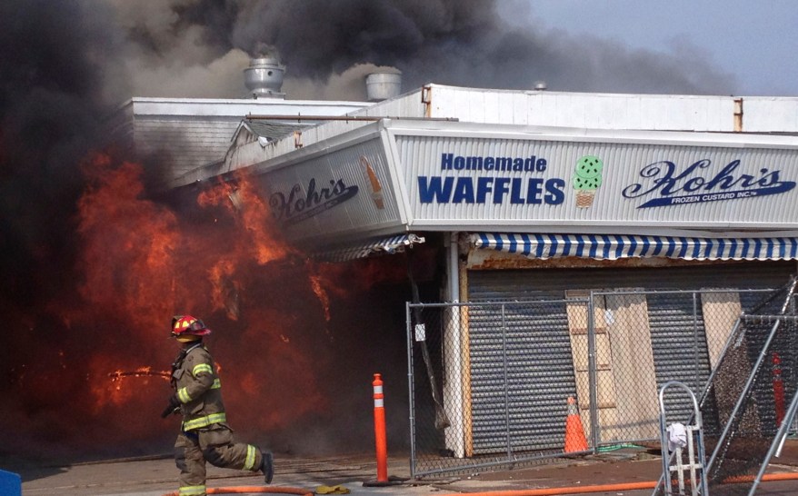 Firefighters battle a blaze inside the Kohr's shop on the Seaside Park Boardwalk on Thursday.