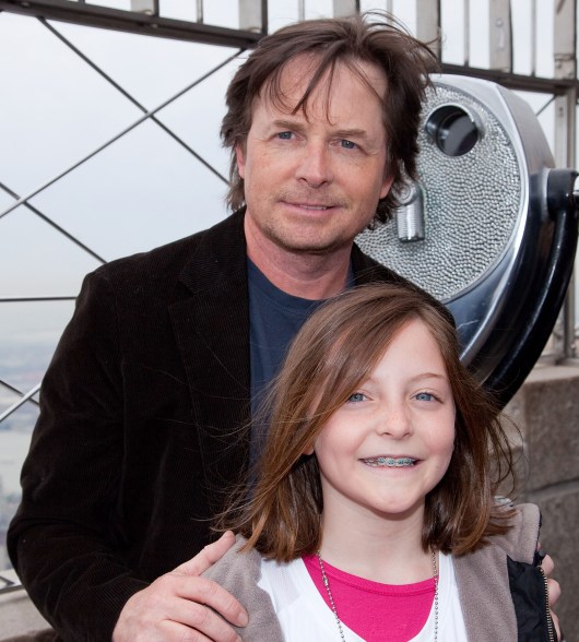 Michael J. Fox and youngest daughter Esme raise awareness for his Foundation for Parkinson's Research at the Empire State building in 2011.