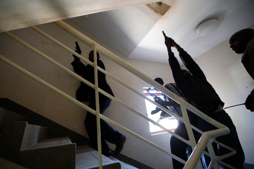 Armed police search through a shopping centre for gunmen in Nairobi