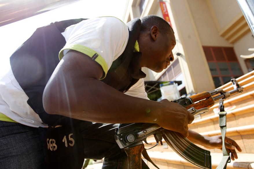 A policeman takes up position during a shootout with armed men at the Westgate shopping mall in Nairobi