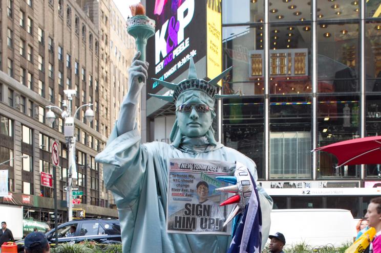 Andy Vega, aka the Statue of Liberty, holding up Wednesday's Post cover.