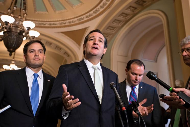 Sen. Ted Cruz, R-Texas, center, accompanied by Sen. Marco Rubio, R-Fla., left, and Sen. Mike Lee, R-Utah, right, express their frustration after the Senate passed a bill to fund the government, but stripped it of the defund "Obamacare" language.