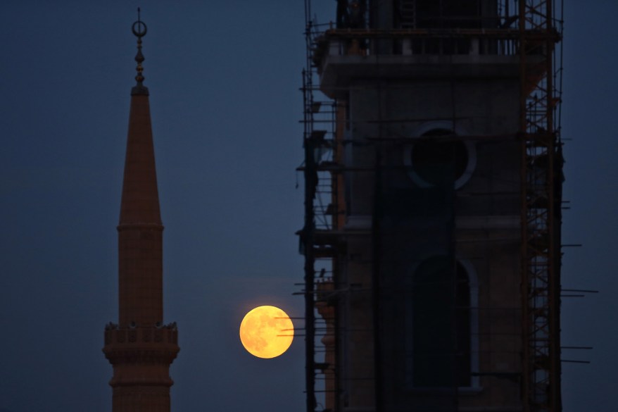 mosque minaret, left, and a church tower under construction, right, in downtown Beirut, Lebanon