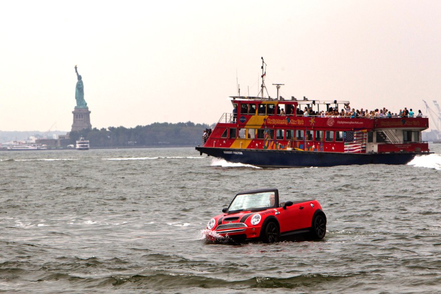 Dwight Miller, of Lancaster, Pa., pilots his Mini Cooper-style boat in the New York Harbor. His unique craft helped publicize the opening of the Motorexpo car show at the World Financial Center in Manhattan.