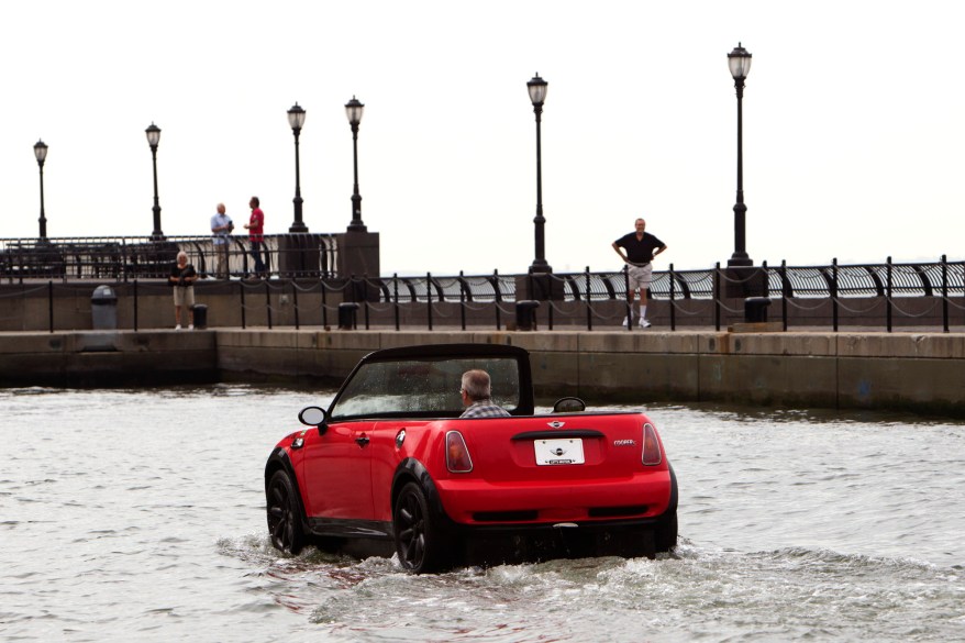 Dwight Miller, of Lancaster, Pa., pilots his Mini Cooper-style boat in the New York Harbor. His unique craft helped publicize the opening of the Motorexpo car show at the World Financial Center in Manhattan.