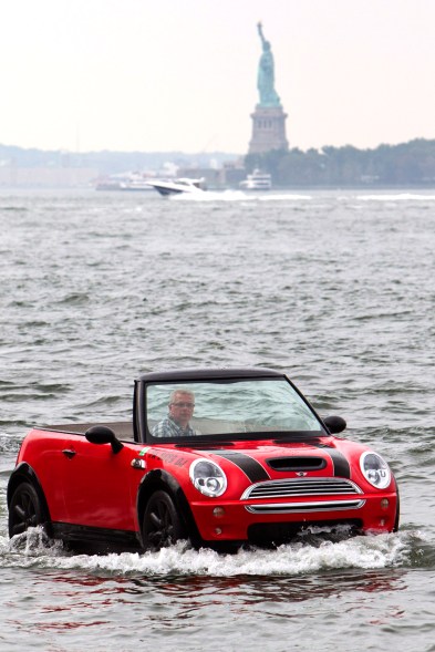 Dwight Miller, of Lancaster, Pa., pilots his Mini Cooper-style boat in the New York Harbor. His unique craft helped publicize the opening of the Motorexpo car show at the World Financial Center in Manhattan.