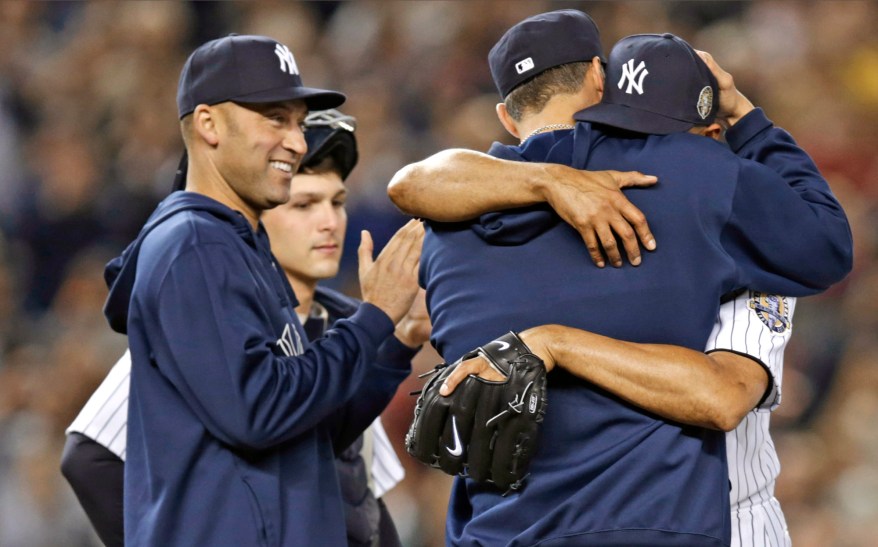 Mariano Rivera hugs Andy Pettitte.