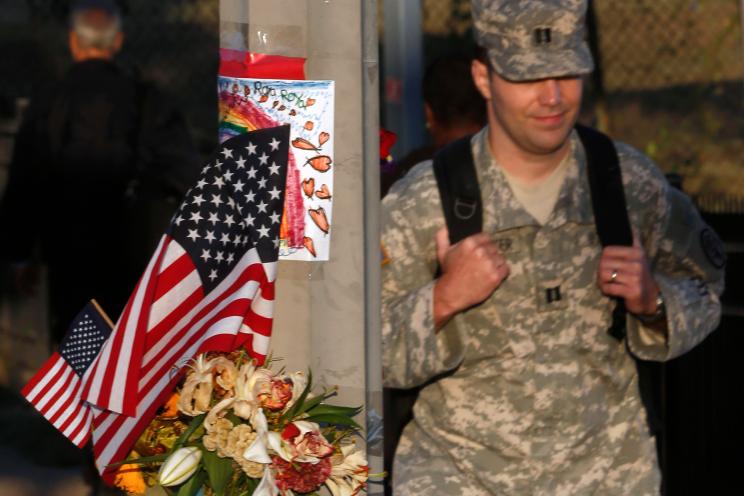 A makeshift memorial is seen on a lamp post across the street from the Washington Navy Yard as military personnel and workers returned to work