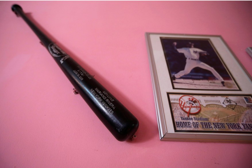 A baseball bat and a framed picture of New York Yankee pitcher Mariano Rivera hang on a wall inside the home of Rivera's father in his hometown of Puerto Caimito, Panama. Around this Pacific fishing village he is still known by the nickname "Pili.''