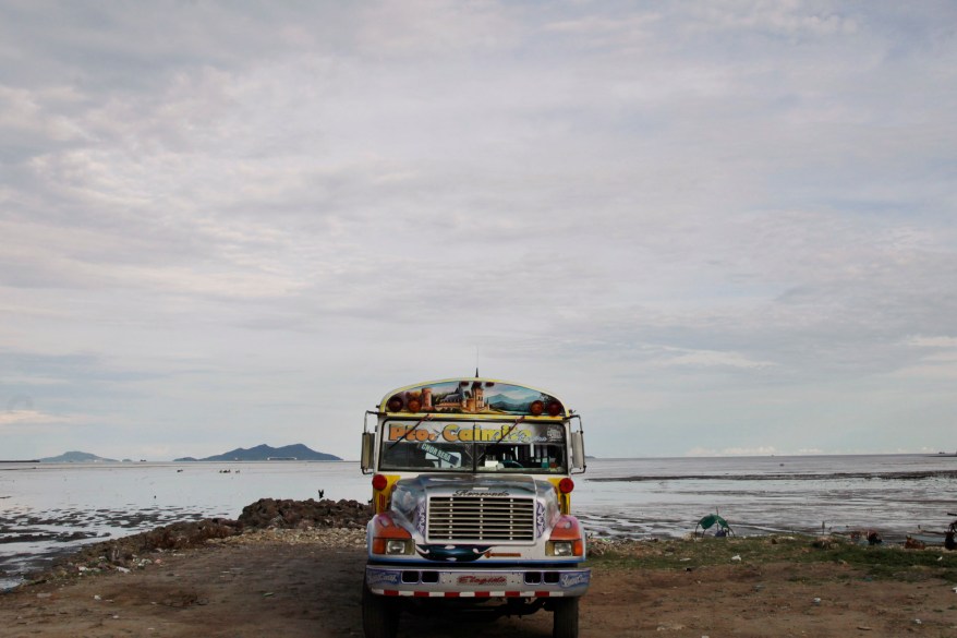 A bus waits for commuters along the beach where New York Yankee pitcher Mariano Rivera played during his childhood in his hometown of Puerto Caimito, Panama. Rivera, who debuted in 1995, will retire this season as the career leader in saves and one of the game's most dominating relief pitchers.