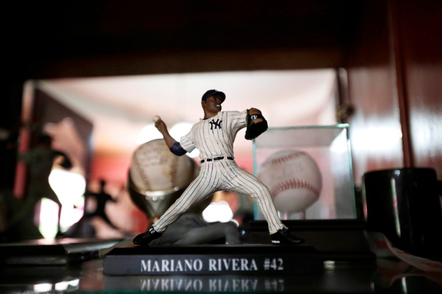 A statue of New York Yankee pitcher Mariano Rivera stands with other memorabilia at his father's home in his hometown of Puerto Caimito, Panama. Around this Pacific fishing village.