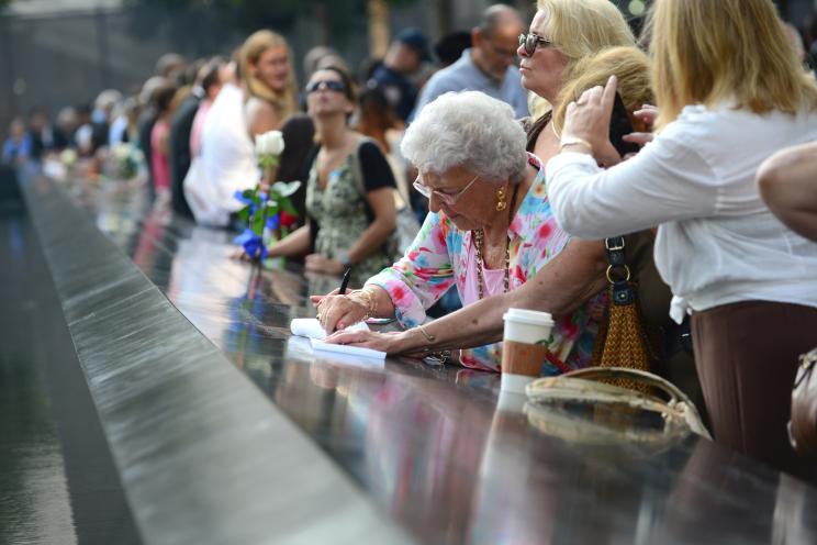 Relatives and friends gather at the 9/11 Memorial during the ceremony marking the 12th anniversary of the attacks on the World Trade Center in New York.