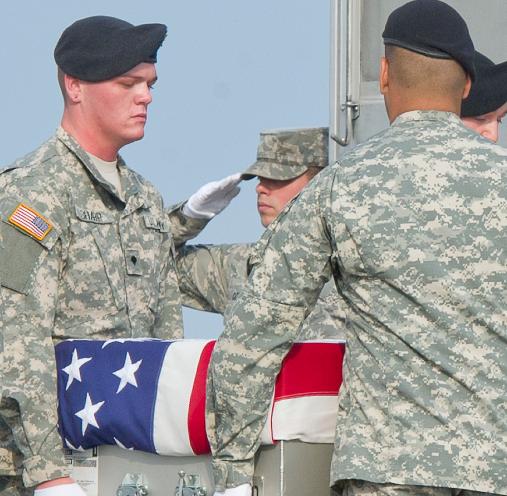 A transfer container holding the remains of Staff Sergeant Michael H. Ollis, United States Army, is transferred in a Dignified Transfer ceremony.