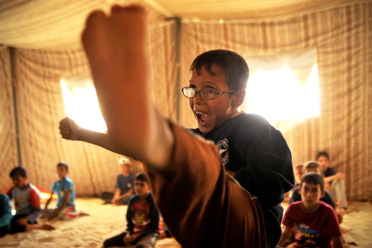 A Syrian refugee boy practices taekwondo during training at Zaatari refugee camp, near Mafraq, Jordan, Tuesday, Sept. 17, 2013