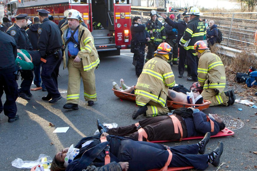 Injured passengers are removed from the derailed Metro-North train.