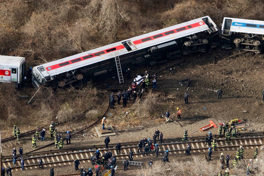 Emergency rescue personnel work the scene of a Metro-North passenger train derailment.