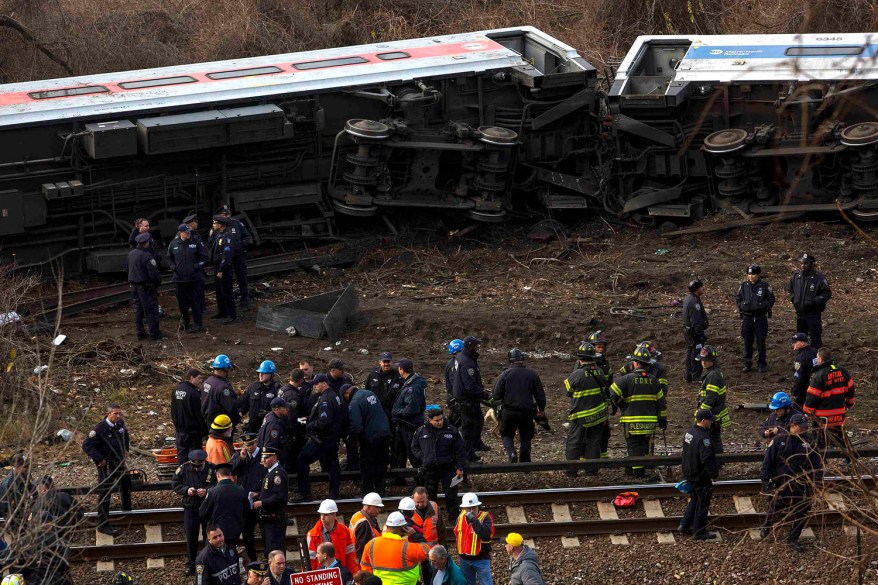 Emergency workers work at the site of a Metro-North train derailment in the Bronx borough of New York