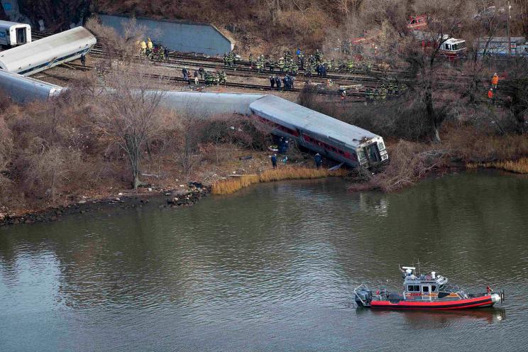 Emergency workers gather at the site of a Metro-North train derailment.