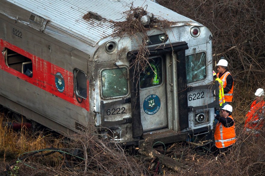 Rescue workers search through a car at the site of a Metro-North train derailment in the Bronx on December 1. Four were killed and 63 were injured.