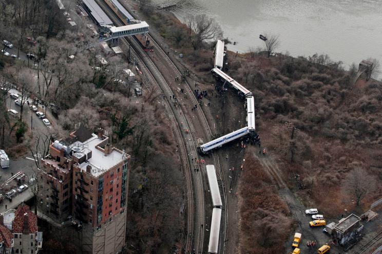 A Metro-North passenger train lays on it's side after derailing in the Bronx on Sunday. Four people were killed.