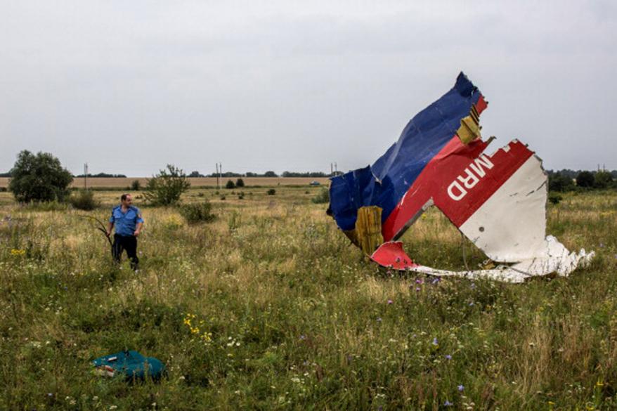 A Ukrainian police officer searches for human remains.