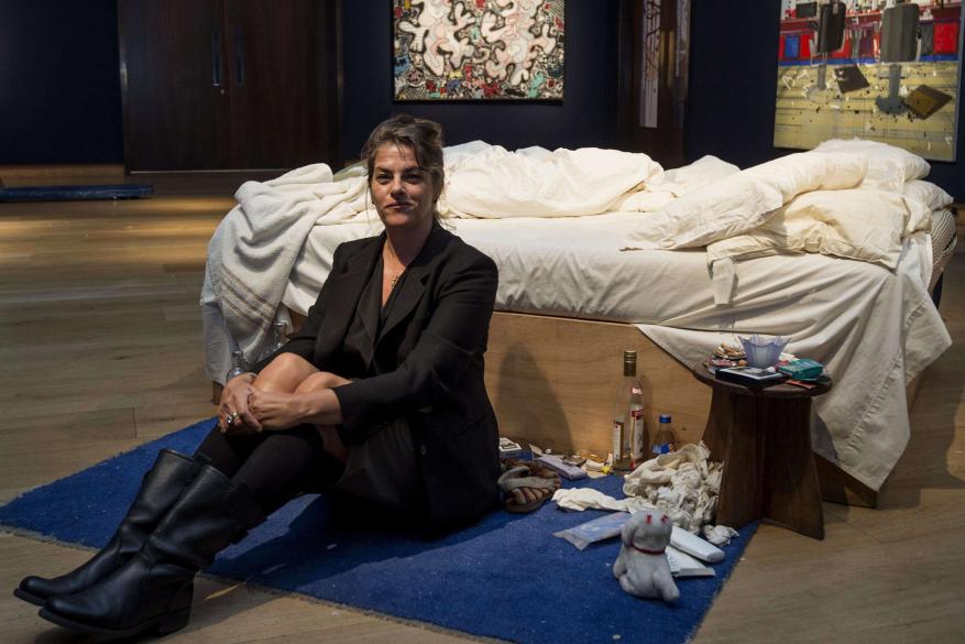 British artist Tracey Emin sits on her iconic art installation, "My Bed"