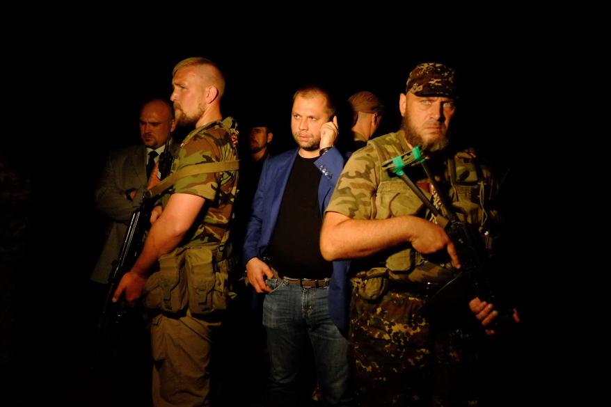 Self-proclaimed Prime Minister of the pro-Russian separatist "Donetsk People's Republic" Alexander Borodai, center, stands as he arrives on the site of the crash .