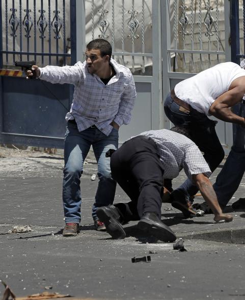 Israeli undercover policemen, one holding a gun, arrest a Palestinian (R) during clashes following traditional Friday prayers near the Old City in East Jerusalem on July 25, 2014. Israeli security forces are on heightened alert after a Palestinian man was shot dead during a huge protest in the West Bank against Israel's military offensive in Gaza. Palestinian factions in the West Bank declared a "Day of Rage" after the previous night's clashes around the West Bank and in some sectors of Israeli-annexed east Jerusalem. AFP PHOTO / AHMAD GHARABLIAHMAD GHARABLI/AFP/Getty Images