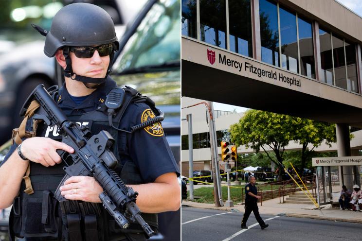 An officer stands guard near the scene of a shooting Thursday, July 24, 2014, at Mercy Fitzgerald Hospital in Darby, Pa.