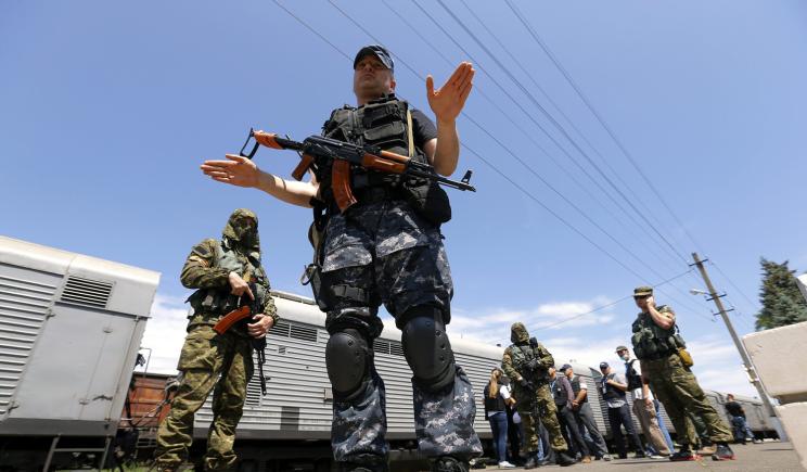 Armed rebels guard a train carrying the bodies of the victims of Malaysia Airlines Flight 17 on Sunday.