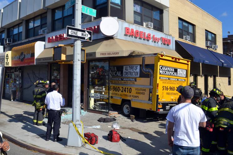 The scene where a truck smashed into a storefront in Queens.