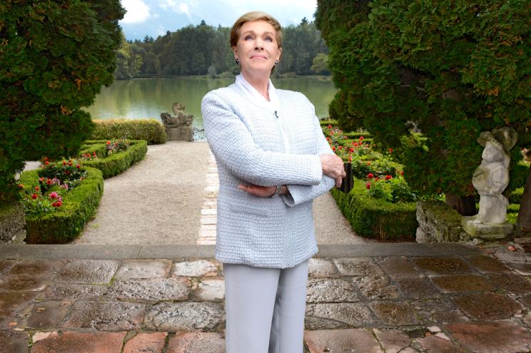 Julie Andrews stands at the lakeside terrace Schloss Leopoldskron, which was used as one of the main exterior locations for ‘The Sound of Music.’