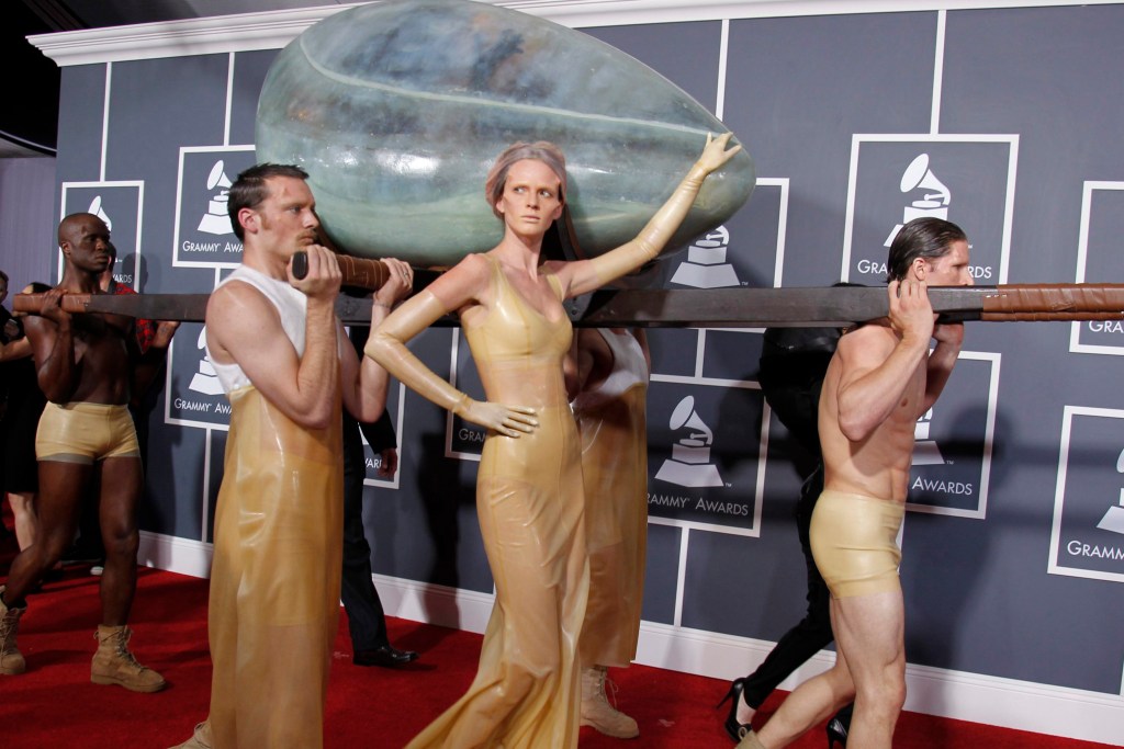 Lady Gaga being carried in an egg-shaped vessel by persons in dresses at the 53rd annual Grammy Awards, 2011 in Los Angeles