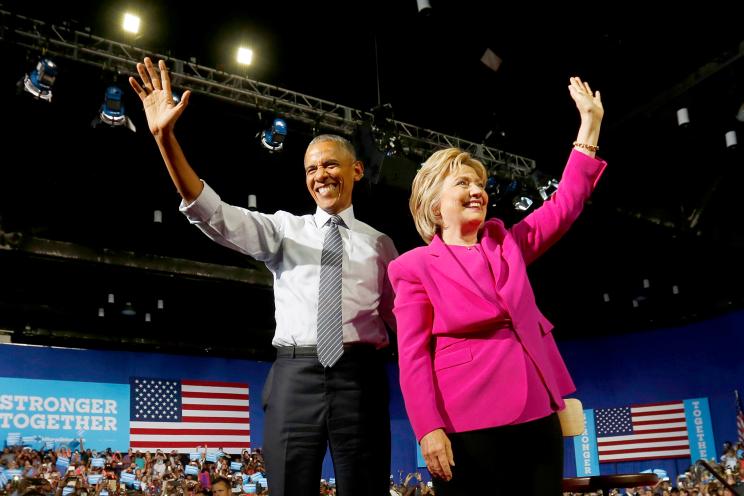 Barack Obama waves to the crowd with presidential candidate Hillary Clinton during a campaign event in Charlotte, North Carolina.