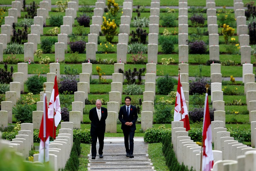 Canadian Prime Minster Justin Trudeau (right) walks with British historian Tony Banham after laying a wreath at Sai Wan war cemetery, where some Canadian soldiers who died in World War Two were buried, in Hong Kong.