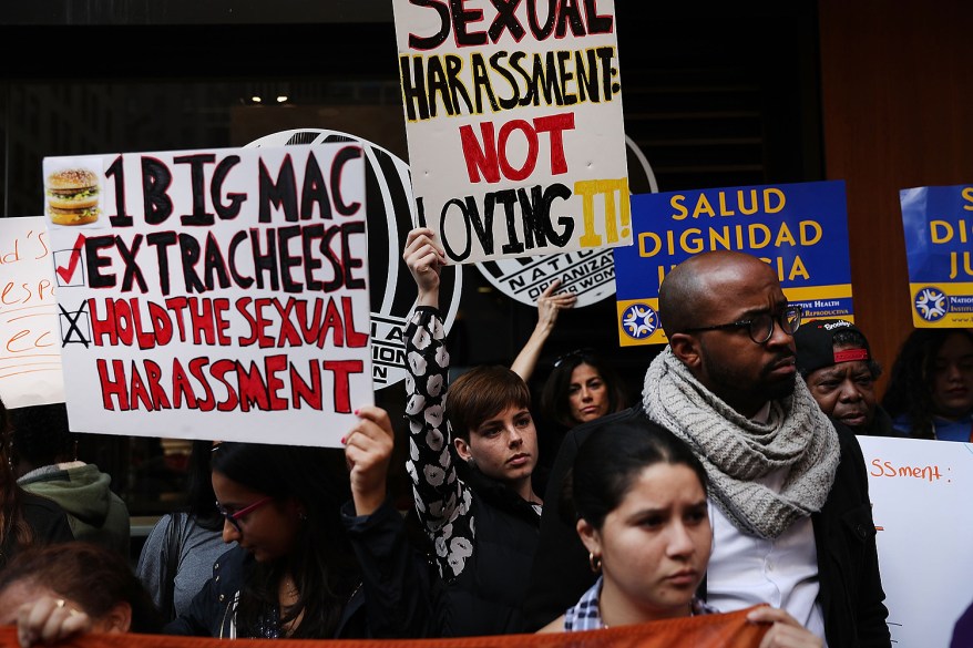 Protesters demonstrate outside of a McDonald's restaurant near Times Square after charges were brought against the company that they have ignored serious instances of sexual harassment.