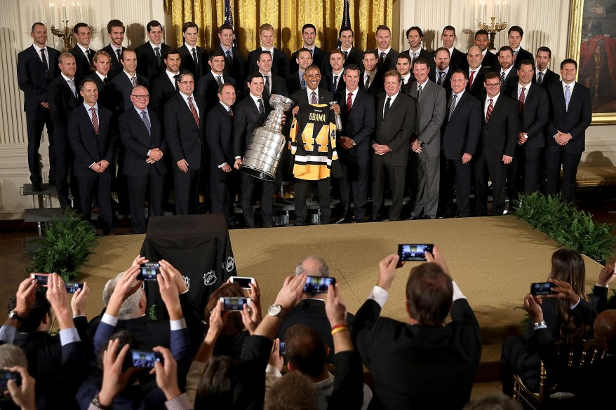 President Barack Obama poses for photographs with the National Hockey League champion Pittsburgh Penguins while celebrating their Stanley Cup victory in the East Room of the White House.