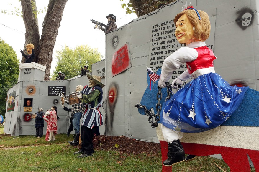 A Halloween display featuring a border wall and figures of Donald Trump, Hillary Clinton and Bernie Sanders is seen on the property of Matt Warshauer in West Hartford, Connecticut.