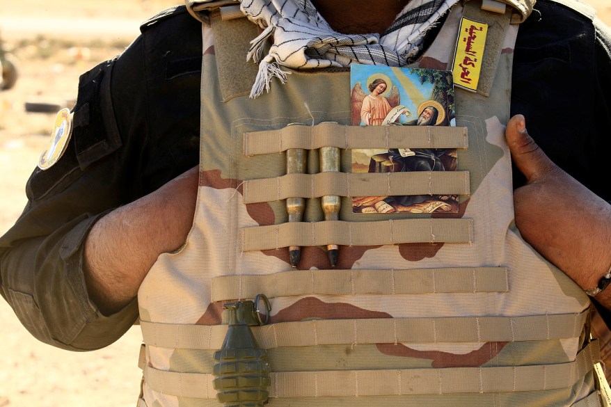 A Christian fighter supporting Shi'ite forces wears a vest in Ali Rash, Iraq.